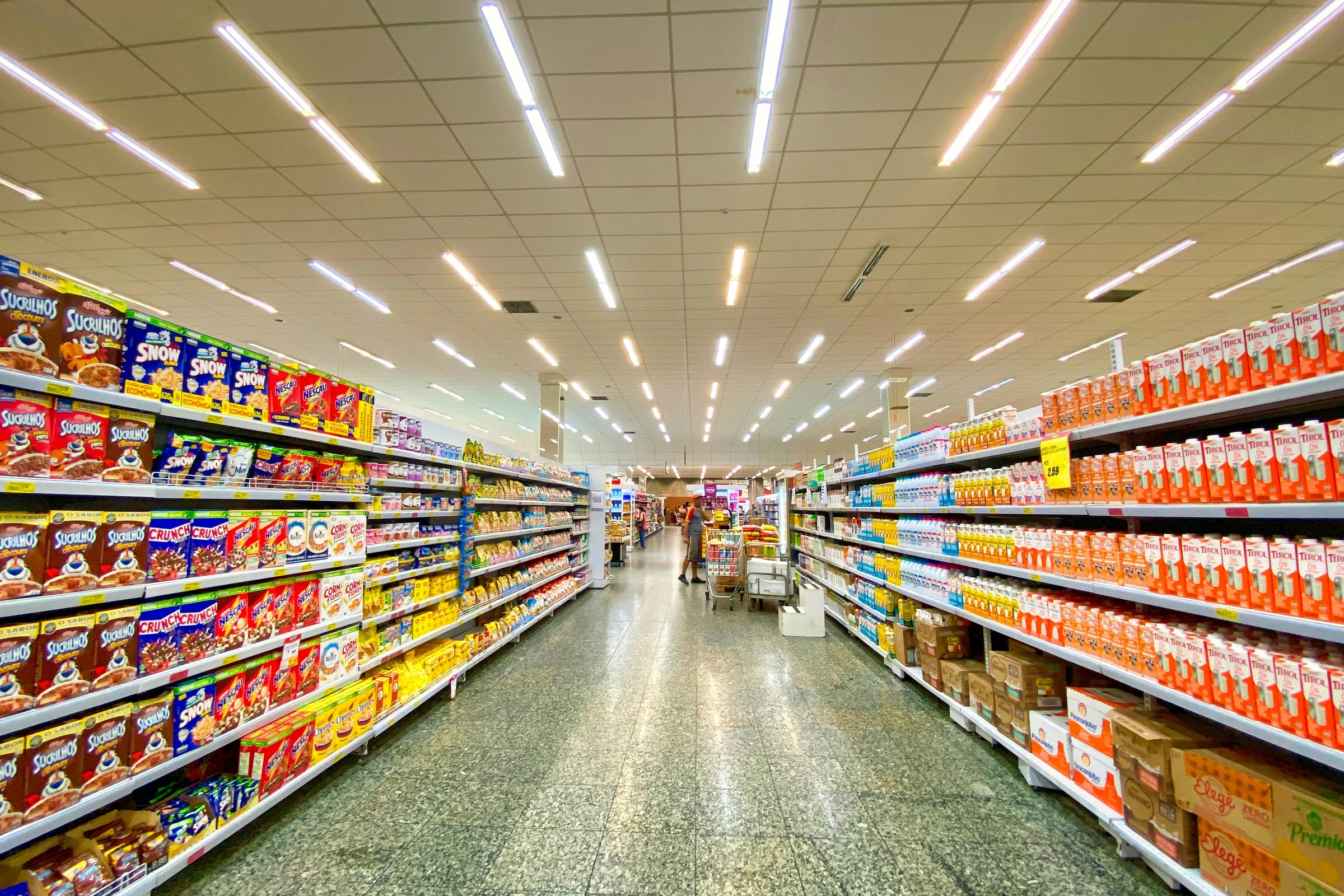 Supermarket shelves stocked with packaged everyday consumer goods