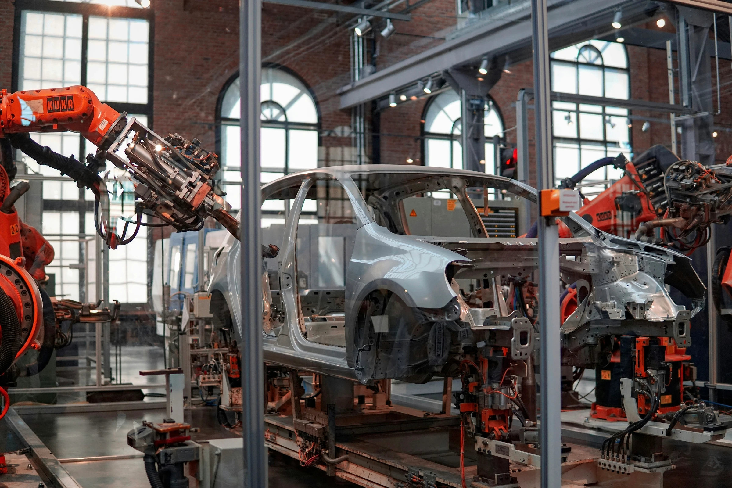 Industrial robots assembling a vehicle on a factory production line